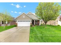 Charming single-Gathering home features a two-car garage, lush lawn, and inviting curb appeal at 4809 Ozark Ln, Indianapolis, IN 46239