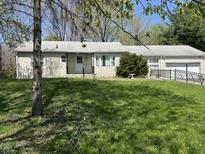 Charming ranch-style home featuring a well-maintained lawn and accessible ramp at 5822 W 62Nd St, Indianapolis, IN 46278