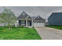 Charming one-story home with a two-car garage, manicured lawn, and inviting front porch at 6118 Aspen Meadow Dr, Indianapolis, IN 46237
