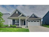 Charming single-story home with a well-manicured lawn and a two-car attached garage, exuding curb appeal at 6118 Aspen Meadow Dr, Indianapolis, IN 46237