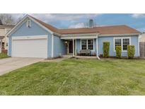 Charming blue single-Gathering home with an attached garage and well-maintained lawn at 6602 Cobden Ct, Indianapolis, IN 46254