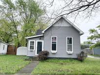 Charming gray home with tidy landscaping, inviting entrance, and Indiana Hoosiers banner in window at 741 Walnut St, Franklin, IN 46131