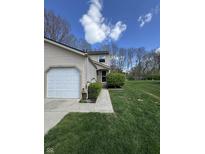Charming home with a manicured lawn, walkway, and a bright, inviting exterior under a sunny sky at 9415 Timber View Dr, Indianapolis, IN 46250