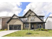 Charming two-story home with a brick and shingle exterior, black trim, and a well-manicured lawn at 9920 Deep Royal Way, Indianapolis, IN 46239