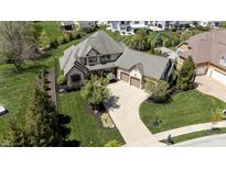 Stunning exterior elevation of home with manicured landscaping and curved driveway leading to the two-car garage at 10138 Backstretch Row, Fishers, IN 46040