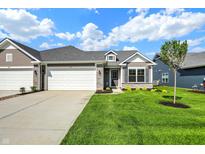 Charming home with a gray roof, two-car garage, stone accents, and a well-manicured lawn under a sunny sky at 110 Maxim Ct, Cumberland, IN 46229