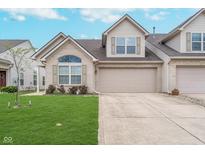 Charming home with a two-car garage, manicured lawn, and beautiful brick and vinyl siding at 12698 Whisper Way, Fishers, IN 46037