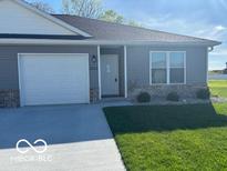 Charming single story home with gray siding, brick accents, and a well-maintained lawn at 1511 Coen Ct, Columbus, IN 47201