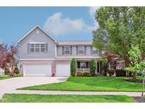 Charming two-story home with a manicured lawn, complemented by a two-car garage and gray siding at 19248 Searay Dr, Noblesville, IN 46060