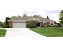 Charming single-story brick home with a well-manicured lawn and attached two car garage at 215 Fairway Ct, Franklin, IN 46131