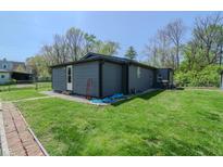 A spacious backyard with green grass surrounds the exterior of the home, offering a serene outdoor space at 2658 S Rybolt Ave, Indianapolis, IN 46241