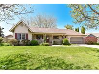 Charming ranch-style home with a well-maintained lawn, inviting porch, and attached two-car garage at 3027 Ash Way, Lapel, IN 46051