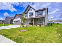 Beautiful two-story home featuring a manicured lawn, brick accents, and a two-car garage at 3148 Hawking Ct, Danville, IN 46122