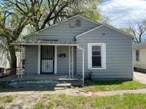 Charming home featuring gray siding, covered front porch, and well-maintained yard at 3541 Orchard Ave, Indianapolis, IN 46218