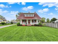 Charming two-story home with landscaped yard, front porch, red shutters, and new roof at 429 E Main St, Whiteland, IN 46184