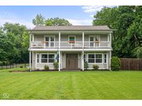 Charming two-story home with a spacious porch, well-maintained lawn, and beautiful curb appeal at 4904 Kessler Blvd N Dr, Indianapolis, IN 46228