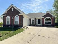 Charming single-story brick home featuring a well-manicured lawn and inviting curb appeal at 6231 Oak Limb Ct, Indianapolis, IN 46221