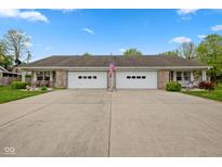 Charming duplex with attached garages and a well-manicured lawn provides an inviting curb appeal at 6640 S New Jersey St, Indianapolis, IN 46227