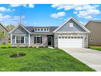 Charming single-Gathering home featuring stone accents and a two-car garage at 7136 Jackson Dr, Cumberland, IN 46229