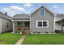 Charming home featuring a covered front porch, manicured lawn, and neutral siding at 842 Miller Ave, Shelbyville, IN 46176
