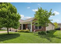 Charming single-story home with a well-manicured lawn and mature trees at 8855 Banner Dr, Brownsburg, IN 46112