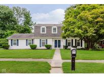 Charming two-story home with a well-manicured lawn, mature trees, and classic curb appeal at 1101 High Ct, Carmel, IN 46033