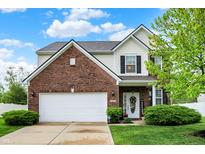 Charming two-story brick home with an attached garage and well-manicured lawn at 1141 Lazio Ct, Greenwood, IN 46143