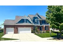 Beautiful two-story home featuring blue siding, brick accents, and a well-maintained lawn at 13766 Heatherfield Dr, Fishers, IN 46038