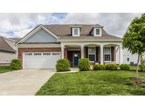 Charming brick home with a well-manicured lawn, covered entry, and a two-car garage at 14878 Anees Ln, Fishers, IN 46040