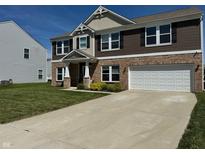 Charming two-story home with a brick and siding exterior and a well-maintained front yard at 2068 Deer Valley Ct, Columbus, IN 47201