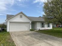 Charming one-story home featuring a front-facing garage and a well-maintained front yard at 3019 Knobstone Ln, Indianapolis, IN 46203