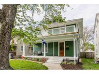 Charming two-story home with a inviting front porch and second floor balcony at 328 N Layman Ave, Indianapolis, IN 46219