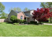 Charming two-story home with brick accents, mature landscaping, and a well-manicured lawn at 4257 Locust Ln, Brownsburg, IN 46112