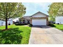Charming single-story home with a manicured lawn, a stone facade, and an attached two-car garage at 5809 Scotland St, Indianapolis, IN 46234