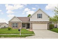 Charming brick and siding home with a well-maintained lawn and a two-car garage in a suburban neighborhood at 5864 Mustang Ter, Plainfield, IN 46168