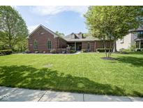 Charming brick home with a lush green lawn and mature trees, offering great curb appeal at 5925 Silas Moffitt Way, Carmel, IN 46033