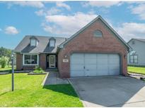Charming brick home with a two-car garage, dormer windows, and well-maintained lawn under a bright sky at 623 White Ash Trl, Mooresville, IN 46158