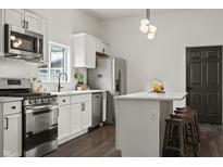Well-designed kitchen featuring stainless steel appliances, white cabinetry, and a functional island at 629 N Keystone Ave, Indianapolis, IN 46201