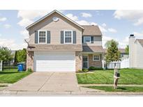 Charming two-story home featuring a two-car garage and a well-manicured front lawn in a suburban neighborhood at 6842 Viola Ct, Indianapolis, IN 46237