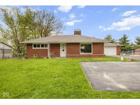 Charming single-story brick home featuring a well-maintained lawn, detached garage and long private driveway at 70 Casco Dr, Avon, IN 46123