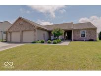 Charming single-story home boasts a well-manicured lawn, two-car garage, and inviting curb appeal at 845 Blackberry Dr, Greenwood, IN 46143