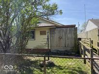 The side of the house features a unique wooden fence and ramp leading to the entrance at 907 W 14Th St, Muncie, IN 47302