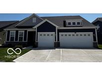 Charming home boasts a two-car garage and well-maintained landscaping, offering great curb appeal at 1221 Malbec Cir, Westfield, IN 46074