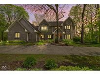 Inviting two-story brick home featuring professional landscaping, walkway, and a large driveway surrounded by lush greenery at 13 Ridgeline Dr, Brownsburg, IN 46112