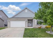 Charming single-story home with a two-car garage, manicured lawn, and lovely landscaping at 1666 Huntzinger Blvd, Pendleton, IN 46064