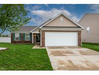 Charming single-Gathering home with brick accents, a two-car garage, and well-maintained landscaping at 2260 Quarter Path Rd, Cicero, IN 46034