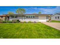 Charming single-story home with a lush green lawn and manicured landscaping at 231 N East St, Pendleton, IN 46064