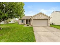 Charming single-story home featuring a two-car garage, brick facade, and well-maintained front lawn at 2523 Gammon Dr, Indianapolis, IN 46234
