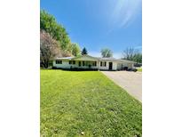Charming single-story home featuring a well-manicured lawn and an attached garage with a spacious driveway at 2871 N Talley Rd, Columbus, IN 47203