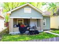Charming single-story home with a front porch, grill, and landscaping at 321 Harlan St, Indianapolis, IN 46201